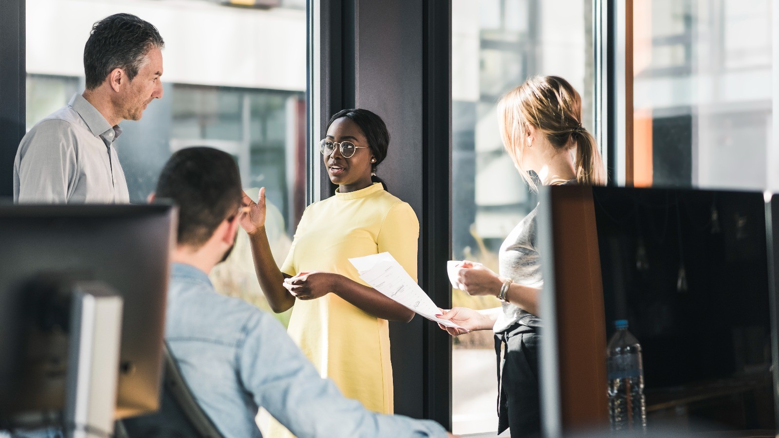 four people working together in an office