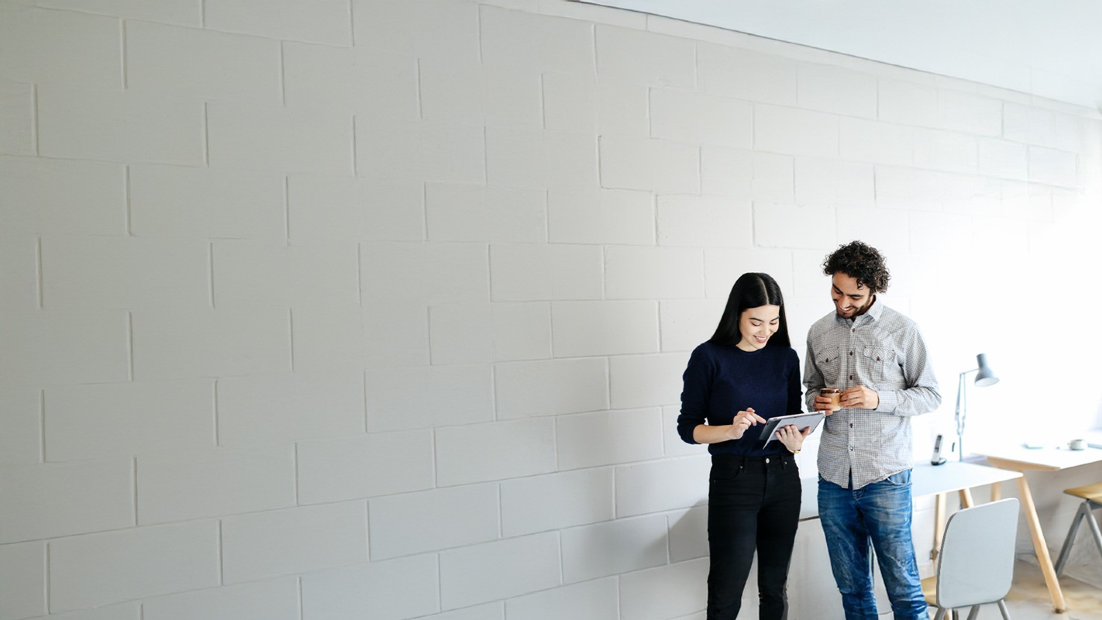 two people working in the office while standing