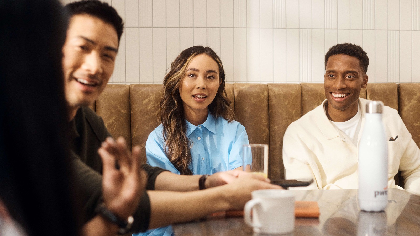 Three people at a table having a conversation