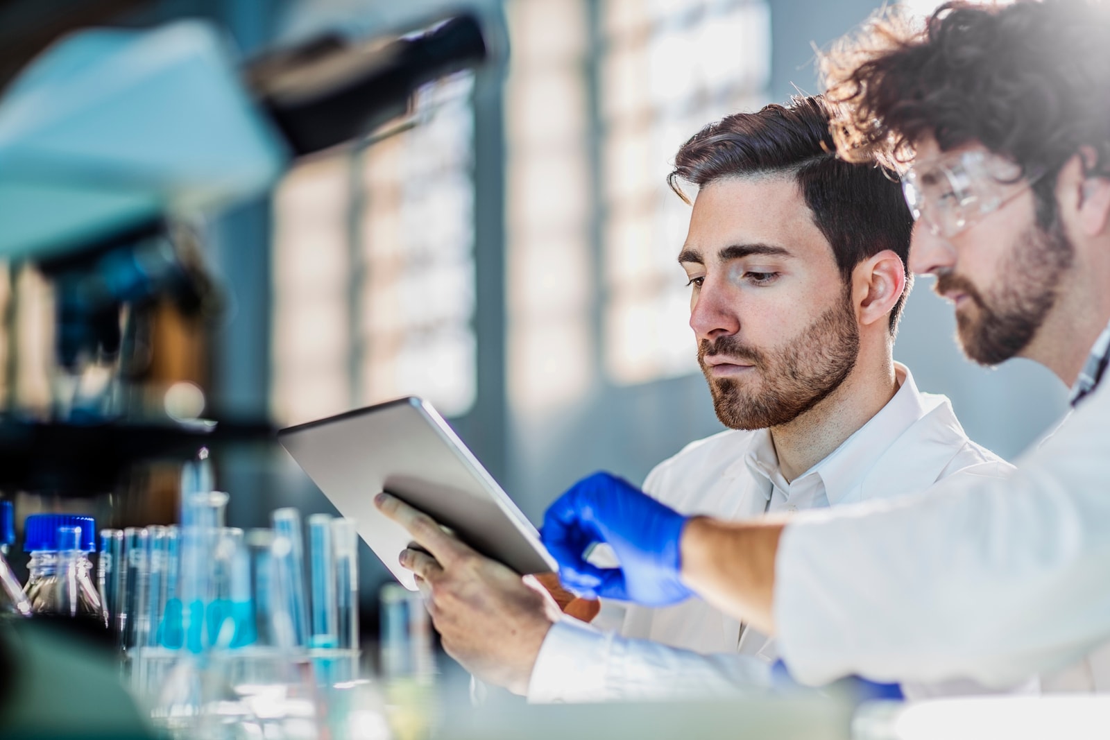 Two scientists in conversation in a laboratory